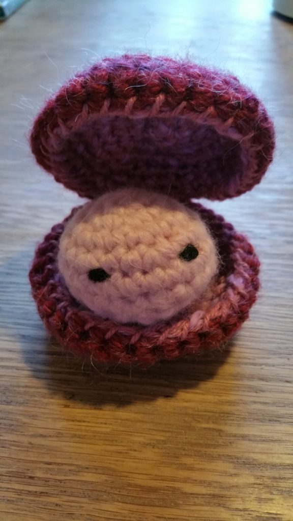 A Little Crocheted Amigurumi Oyster with the shell open