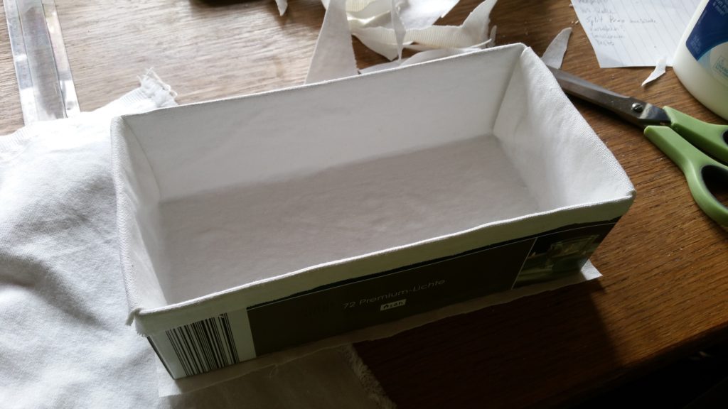Covering a box with white cloth on the inside