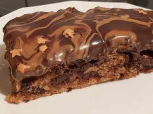 A piece of Banana Chocolate Cake with Chocolate Frosting and little Starts on top