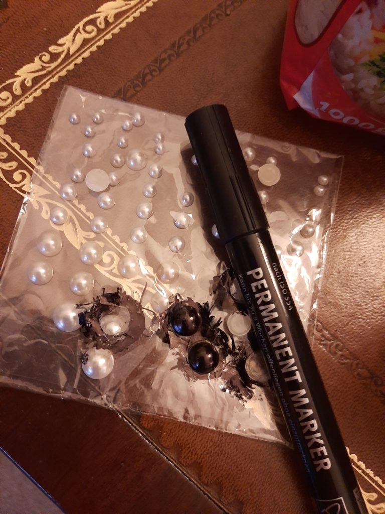 Using half-pearls as eyes painting them black