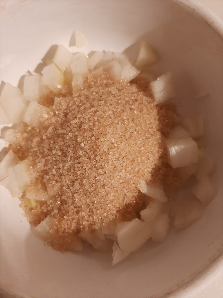 Chopped onions with brown sugar on top to make a home remedy